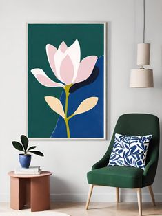 a living room with a green chair and a pink flower on the wall above it