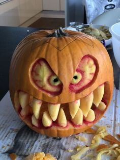 a pumpkin carved to look like a monster with its mouth open and teeth wide open