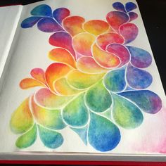 an open book with watercolor designs on it