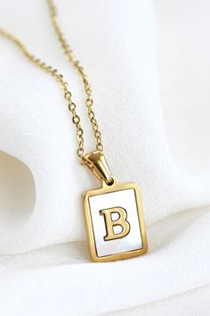 18K Gold Plated Non-Tarnish Stainless Steel Rectangular Tag Initial Necklace. The necklace is hypoallergenic, waterproof, fade-resistant, and tarnish-free, ensuring its beauty lasts for a long time. Pendant size: 0.47" x 0.59" Approx.17.71" long + 2" extender. Mother of Pearl Necklace | Letter Charm Necklace | Initial Pendant Necklace | Name Necklace | Monogram Necklace | Gold Dipped Necklace | Waterproof & Sweatproof Jewelry | Simple Gold Necklace Sweatproof Jewelry, Initial Tag Necklace, Monogram Necklace Gold, Letter Charm Necklace, Purse Essentials, Gold Necklace Simple, Necklace Initial, Jewelry Simple, Mother Of Pearl Necklace