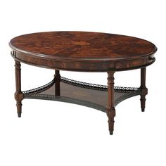 a wooden table with an oval top and ornate carvings on the bottom, sitting against a white background