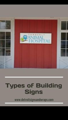 the types of building signs are displayed in front of two large windows, and there is a sign that says animal hospital