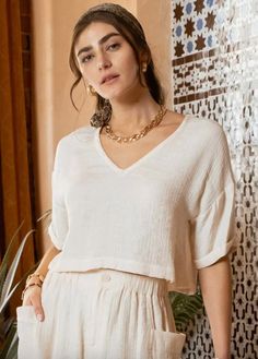 Elevate your basics with the Jocelyn Crinkle Crop Top. This short sleeve, v-neck top features a chic, textured lightweight fabric that adds a touch of sophistication to your look. The cropped length + slightly boxy fit make it trendy + fun. Whether you're dressing up or keeping it casual, the Jocelyn Crinkle Crop Top is your versatile go-to. Pair it with a skirt or dress trousers for a polished, dressy look, or keep it laid-back with denim or cargo pants for an effortlessly stylish outfit. Key E Chic Crinkle Texture V-neck Blouse, Chic V-neck Short Sleeve Top For Day Out, Textured Short Sleeve Blouse For Summer, Textured Short Sleeve Summer Blouse, Chic Short Sleeve Blouse With Crinkle Texture, Chic Textured Short Sleeve Tops, Chic Short Sleeve Textured Tops, Summer Crinkle Texture Short Sleeve Blouse, Small Crop Tops