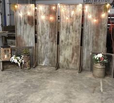 three wooden partitions with lights on them in an industrial warehouse or office setting,