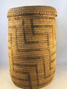 a large woven basket sitting on top of a white table