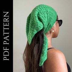 a woman wearing a green knitted hat with a bow on it's head