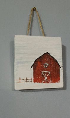 a red barn hanging on the wall