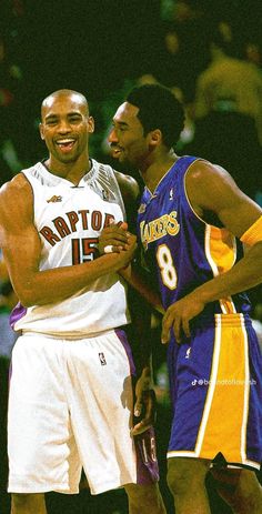 two basketball players standing next to each other