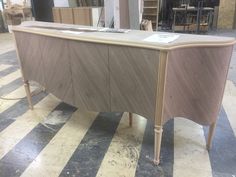 a large wooden desk sitting on top of a checkered floor