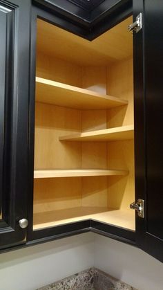 an empty pantry with wooden shelves and granite counter tops in the corner, is shown