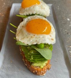 two eggs are on top of a sandwich with lettuce