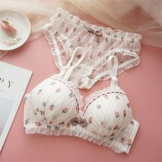 Indulge in the playful charm of the Sweet Delights Cotton Bra Set from StylinArts. This adorable lingerie set features a fun and whimsical pattern, available in strawberry, radish, and peach prints, perfect for adding a touch of sweetness to your everyday wear. The bra is designed with a soft steel ring for upper support, ensuring both comfort and style. Complemented by a matching pair of panties, this set is crafted from high-quality cotton, providing a soft and breathable feel. The bow detail Bra Design, Spring Pink Bra With Removable Pads, Pastel Bra, Pink Coquette Underwire Bra, Feminine Pink Sheer Bra, Kawaii Pink Bra, Cotton Bras, Bras And Panties, Style Japonais