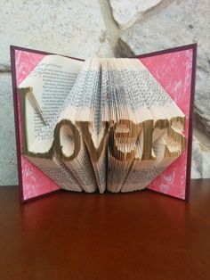 an open book with the word love folded into it