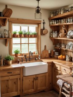 a kitchen filled with lots of wooden cabinets and counter top space next to a window