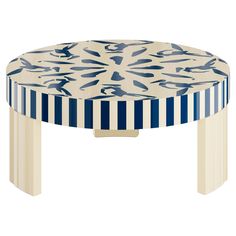 a blue and white striped table with an abstract design on it's top, sitting in front of a white background