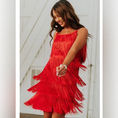 Fun Red Dress With Layered Fringe. 100% Polyester Elegant Red Dress With Fringe, Elegant Red Fringe Dresses, Flirty Sleeveless Holiday Dress, Red Flirty Dress For Holidays, Flirty Red Dress For Holiday, Red Fringe Party Dress, Red Fringed Party Dresses, Red Fringe Dress For Party, Red Fringe Summer Dress