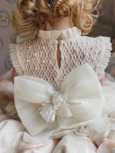 Petite Maison Kids. Made in Turkey. Delicate tulle and lace with faux pearl details on bodice. Back Bow with Bells decoration. The color is Buttermilk Ivory. This two piece set includes blouse and bloomers.