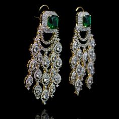 Opt for luxurious modernity! Extravagant chandelier earrings with glimmering CZ stones and an emerald/sapphire accent. Approximate earrings length is 3". Designed over a high quality brass as base metal. Made by order. Kindly allow 4-6 weeks for the delivery of this item. For custom or urgent requests, please contact support@alacouture.com. *Please Note: We use faux stones and beads in all of our jewelry. Faux Stone, Gold Polish, Cz Stone, Chandelier Earrings, Base Metal, Emerald, Sapphire, Brass, Drop Earrings