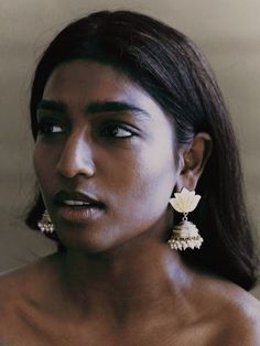 an image of a woman with earrings on her face