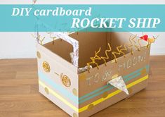 an open cardboard box with the words diy cardboard rocket ship in it on a wooden floor