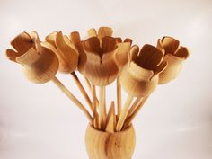 a wooden vase filled with flowers on top of a table