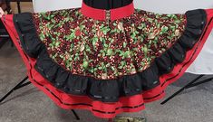 "Holly    This a New ,one of a kind ,Holiday skirt, never to be made again. It has colours of red, green and black throughout. It has a double skirt ruffle with ribbon accents. It is a size MEDIUM and the skirt extends from 28\"-36\". The skirt length is 23\" from the top of the waistband to the bottom of ruffle. A black, red or green crinoline with matching accessories will complete the outfit. Only the finest materials have been used, the print is 100 % cotton  and the plain is cotton/poly.  A