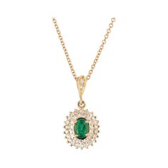 Emerald diamond pendant necklace circa 1950-1960 with a bright green GIA certified natural center emerald with a two row halo of round diamonds in a tiered design. 18k yellow gold chain. 18 inches. 1 oval green MI emerald, Approximate .35ct GIA Certificate #22011105430 39 single cut H-I VS-SI diamonds, Approximate .45ct 14k yellow gold Stamped: 14k Top to bottom: 2.9mm or 13/16 Inches Width: 10.5mm or 3/8 Inch Depth or thickness: 692mm 3.7 grams Chain: 18 Inches Width: 1.3mm Luxury Emerald Diamond Pendant Necklace, Luxury Emerald Necklace With Oval Pendant, Green Pendant Diamond Necklace For Formal Occasions, Formal Diamond Necklace For May Birthstone, Green Diamond Necklace With Halo Setting, Timeless Green Necklace For Formal Occasions, Classic Green Diamond Pendant Necklace, Classic Green Pendant Diamond Necklace, Green Pendant Diamond Necklace In Classic Style