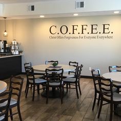 the inside of a coffee shop with tables and chairs