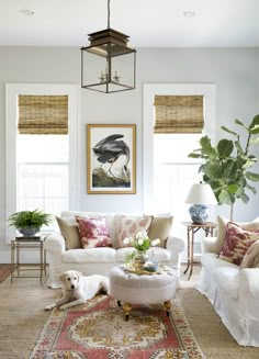 a living room filled with lots of furniture and decor on top of carpeted flooring