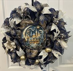 a blue and gold christmas wreath hanging on a door