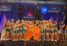 a group of young women standing on top of a stage with confetti in front of them