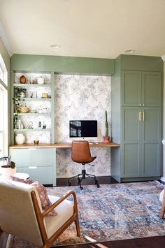 a living room filled with furniture and a flat screen tv on top of a desk