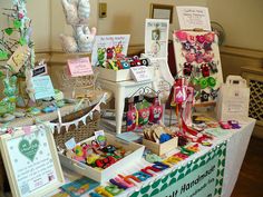 an assortment of items on display at a craft fair, including cards and magnets