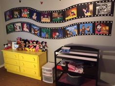 a child's bedroom with mickey mouse pictures on the wall