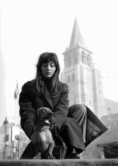 a black and white photo of a woman with her dog