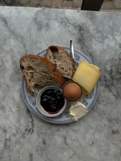 a plate with bread, butter and eggs on it