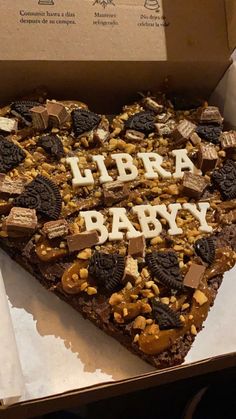 a heart shaped piece of cake with the words libra baby spelled in white letters