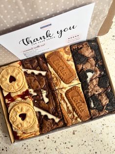 a box filled with cookies and desserts on top of a table