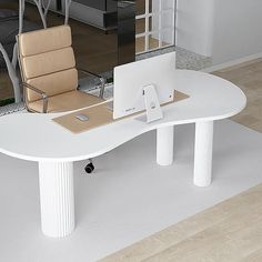 an office desk with a laptop and phone on it