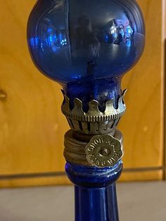 a blue glass vase sitting on top of a table