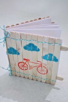 a small wooden book with red and blue bicycle on it