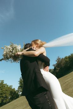 the bride and groom are embracing each other