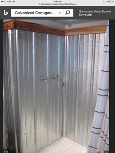 a shower stall is shown with the curtain pulled back to reveal it's metal finish