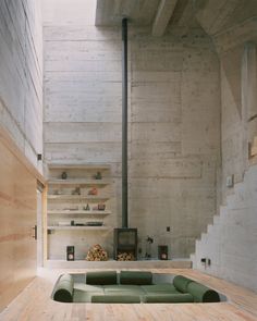 a living room filled with furniture and a fire place next to a wooden flooring wall