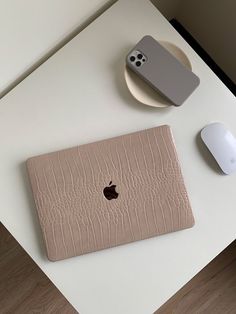 an apple computer sitting on top of a white table next to a mouse and keyboard