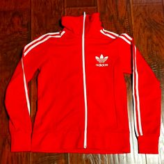 Adidas Originals Women's Trainer Jacket. Polyester Blend. Fitted. Like New, Never Worn. Orange/Red Color. Retro Style. Great Jacket! Red Long Sleeve Track Jacket For Spring, Red Long Sleeve Spring Track Jacket, Fitted Adidas Winter Track Jacket, Fitted Adidas Track Jacket For Winter, Spring Adidas Fitted Track Jacket, Adidas Fitted Hooded Outerwear, Adidas Fitted Track Jacket For Spring, Adidas Fitted Long Sleeve Outerwear, Fitted Long Sleeve Adidas Outerwear