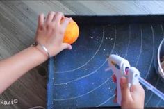 a person is peeling an orange on a cutting board