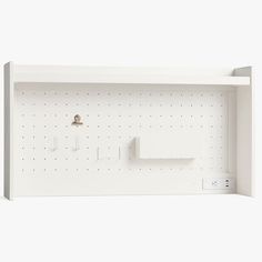 a white wall shelf with several items on it