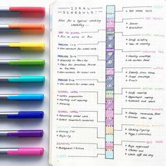 an open notebook with markers and pens on it