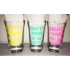 three shot glasses with different colored words on them